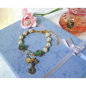 Shell pearl bracelet with gold rocking horse charm